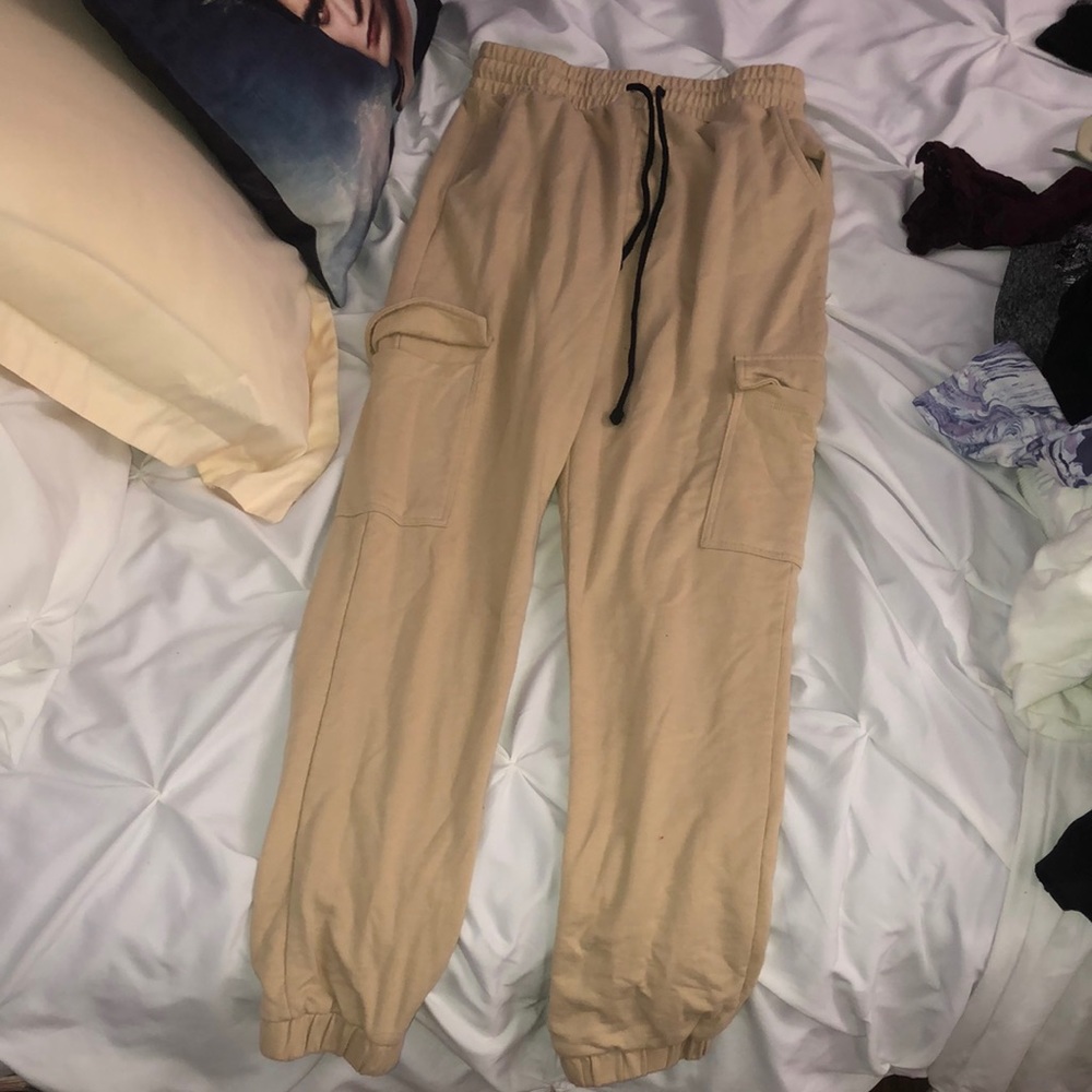 Tan sweatpants with pockets and strings.
